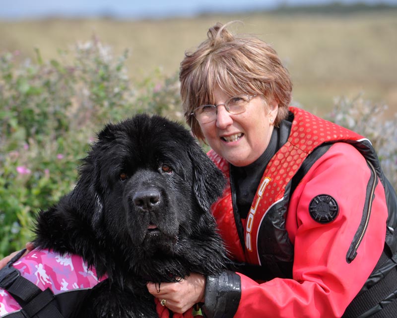 Photograph of Carol Taylor with a black Newfoundand